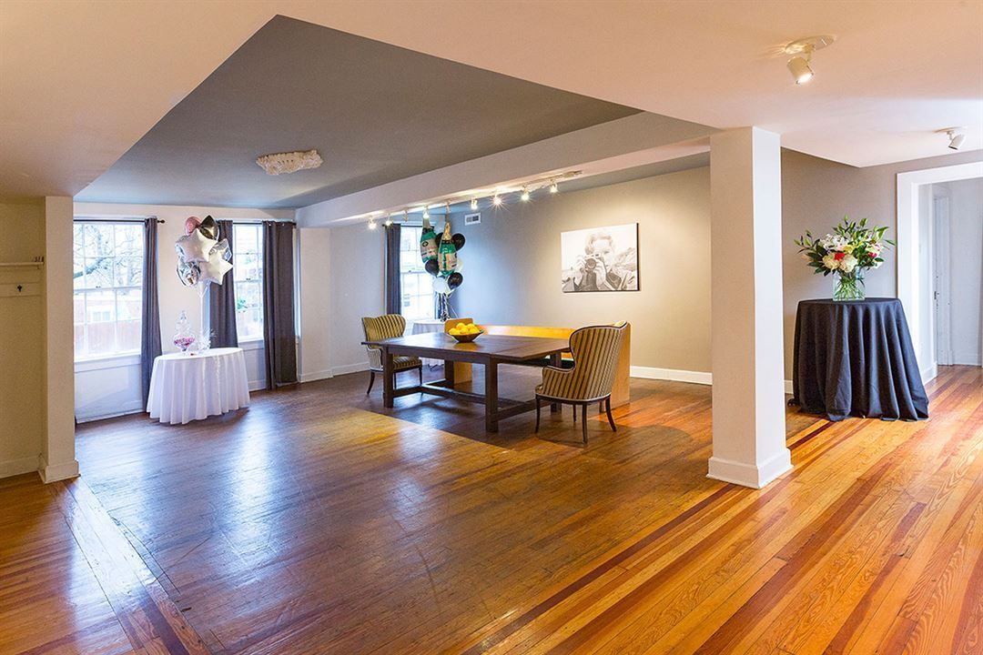The Annex, an open room with original hardwood floors