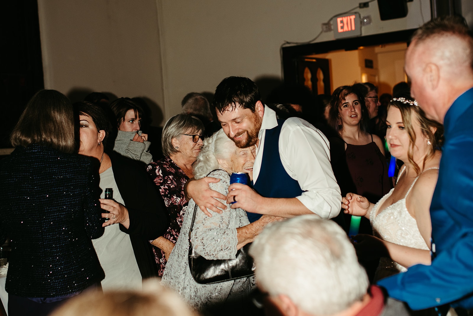 Wedding guests embracing on the dancefloor at Mansion Hill Sanctuary